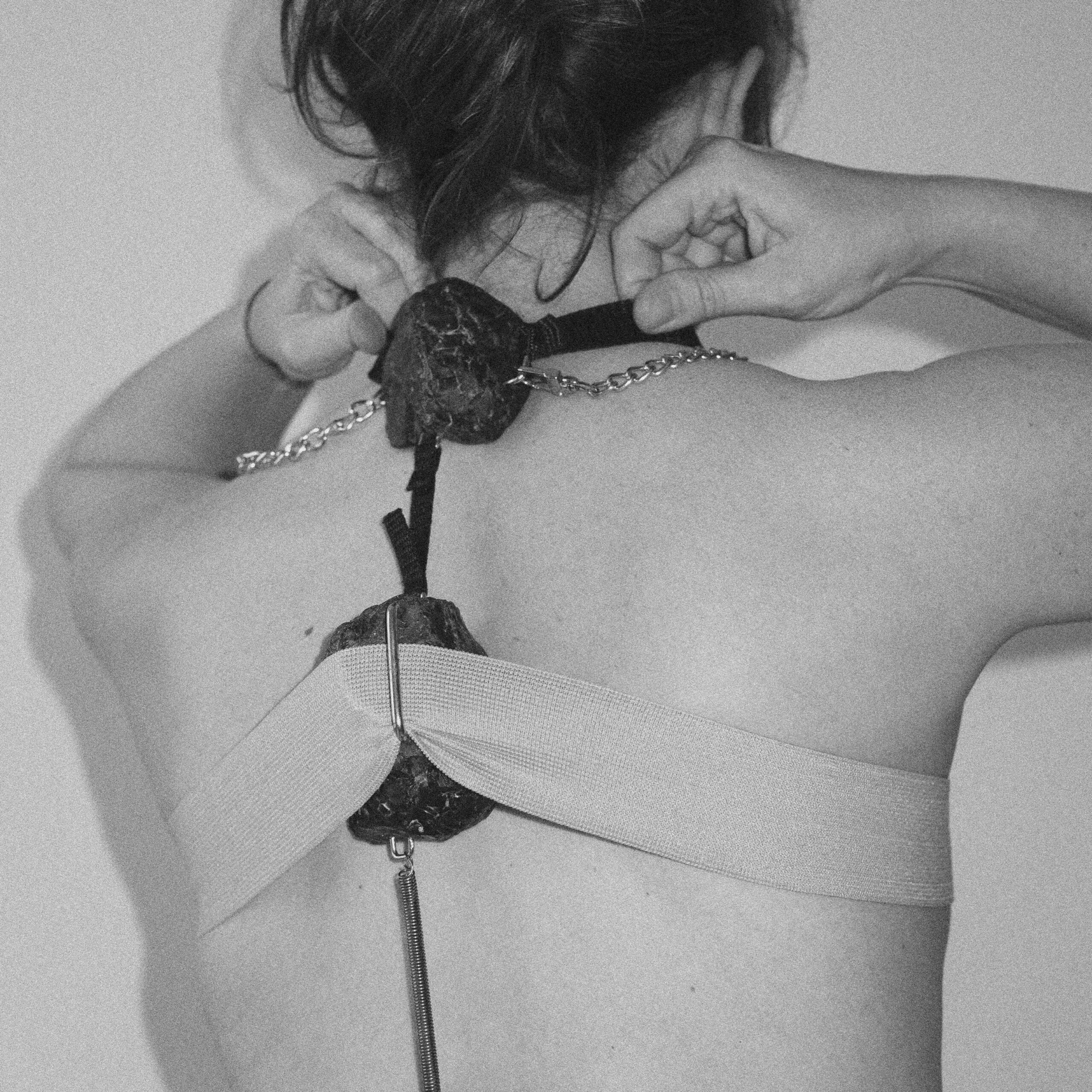 Wiktoria, “Imprint-Sculptures. Wearable”, 2023-2024, carved raw stone, bands, stripes, chains, body, courtesy of the artist